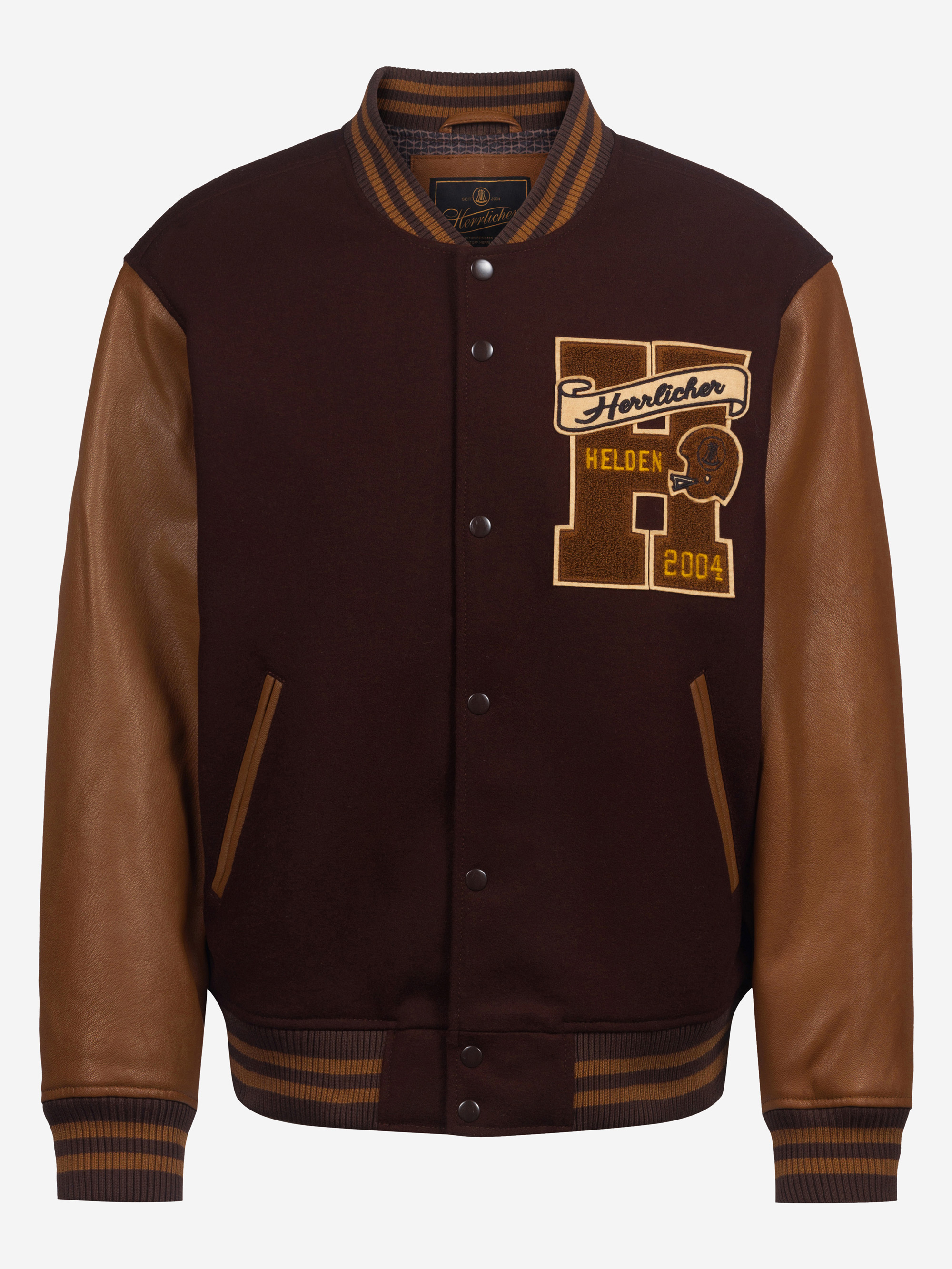 Eine Uniformjacke mit braunen Lederärmeln, einem dunkelbraunen Wollkörper, braun gestreiften Manschetten und gelben Aufnähern mit der Aufschrift "Herzloher Helden 2004" und einem großen H auf der linken Brust.