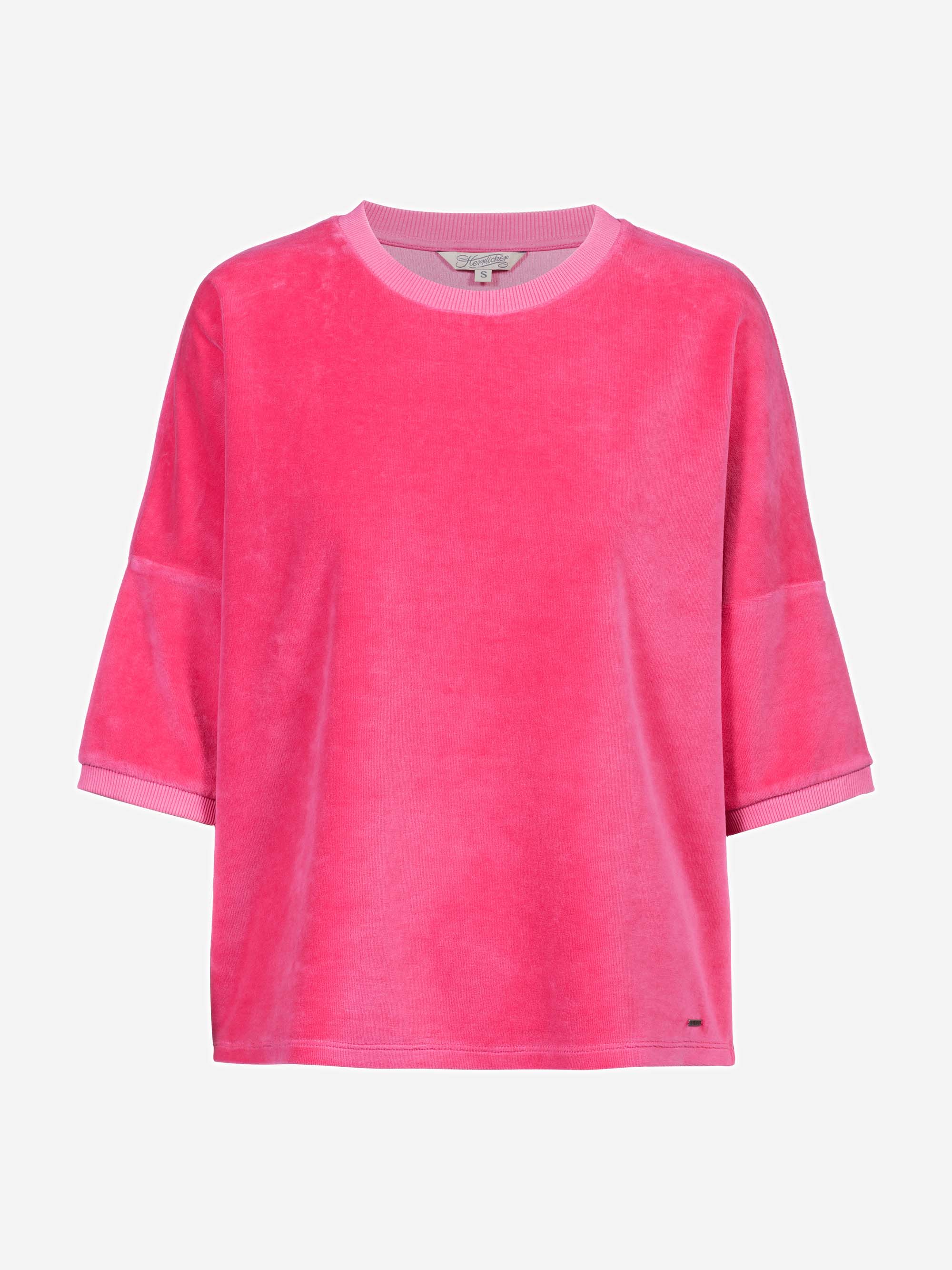 Ein locker sitzendes, kurzärmeliges rosa Velourshemd mit Rundhalsausschnitt und gerippten Abschlüssen, das sich vor einem schlichten hellen Hintergrund präsentiert.