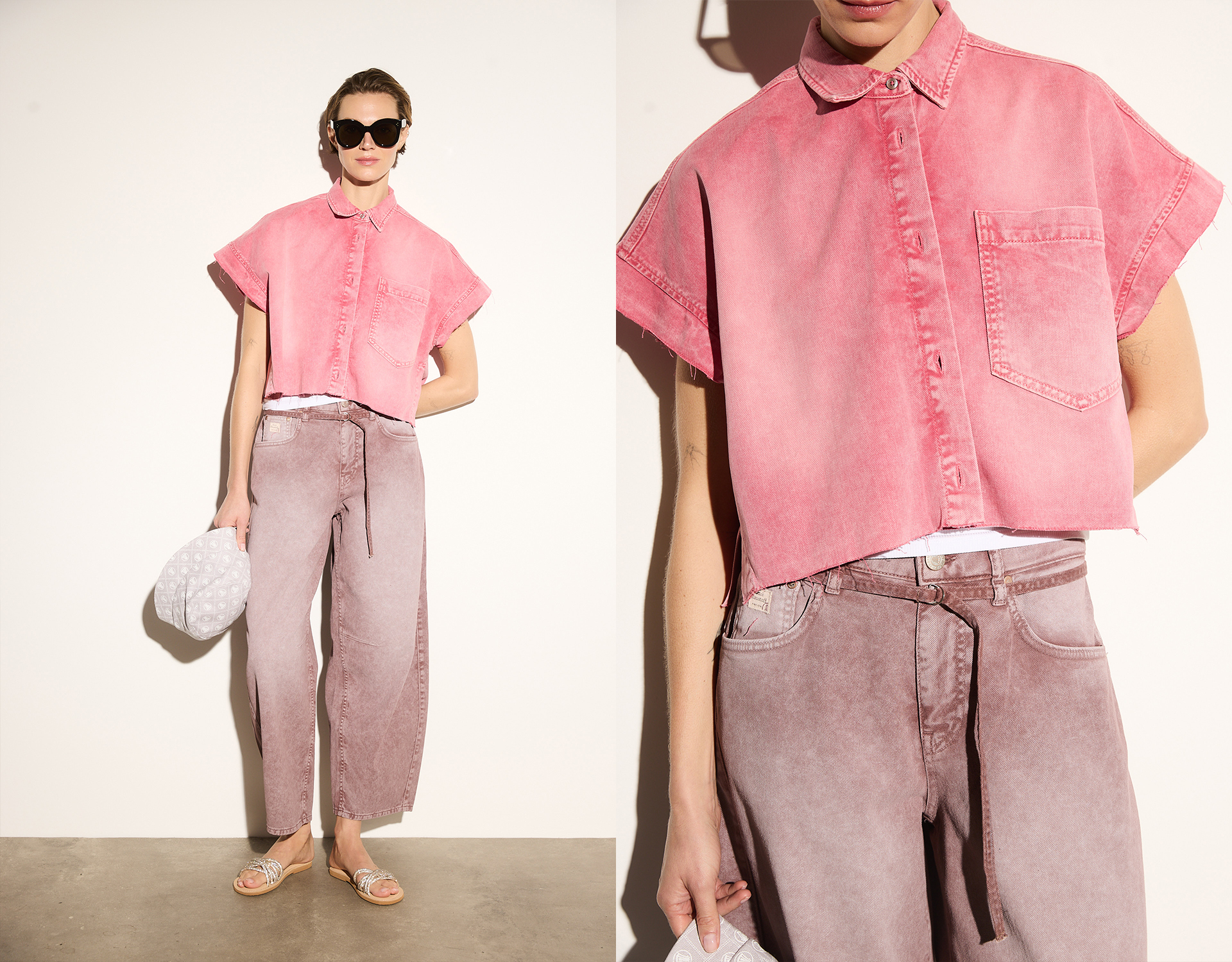 Eine Person, die ein kurzärmeliges, kurzgeschnittenes rosa Jeanshemd und eine weite, hochtaillierte lilafarbene Jeans trägt, steht vor einer schlichten Wand, hält eine strukturierte weiße Tasche in der Hand und trägt eine Sonnenbrille und Sandalen.