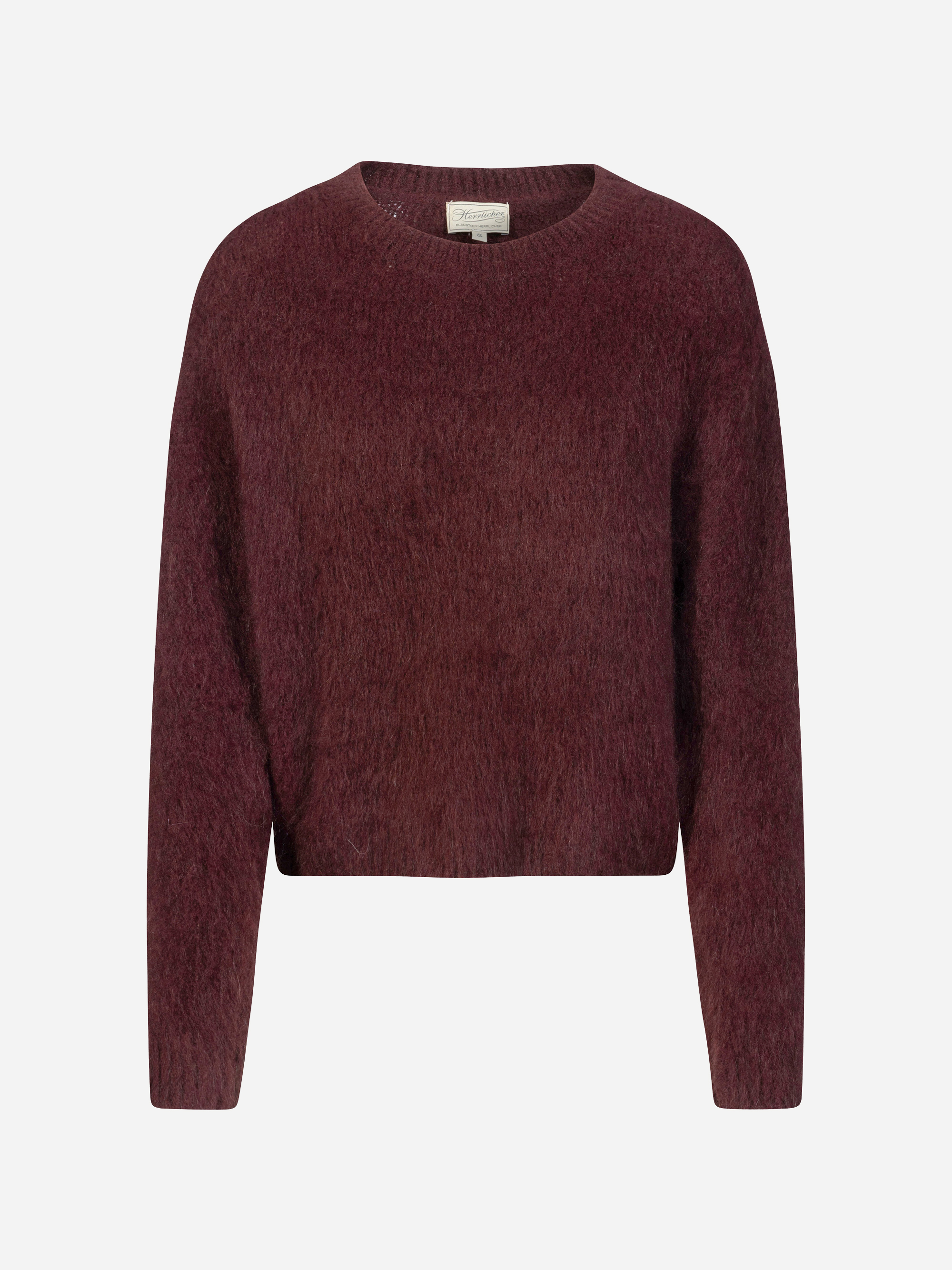 Ein langärmeliger Pullover mit Rundhalsausschnitt in einem satten Burgunderrot, präsentiert vor einem schlichten weißen Hintergrund. Der Pullover wirkt weich und leicht flauschig, hat eine lockere, bequeme Passform und weist keine sichtbaren Muster ode