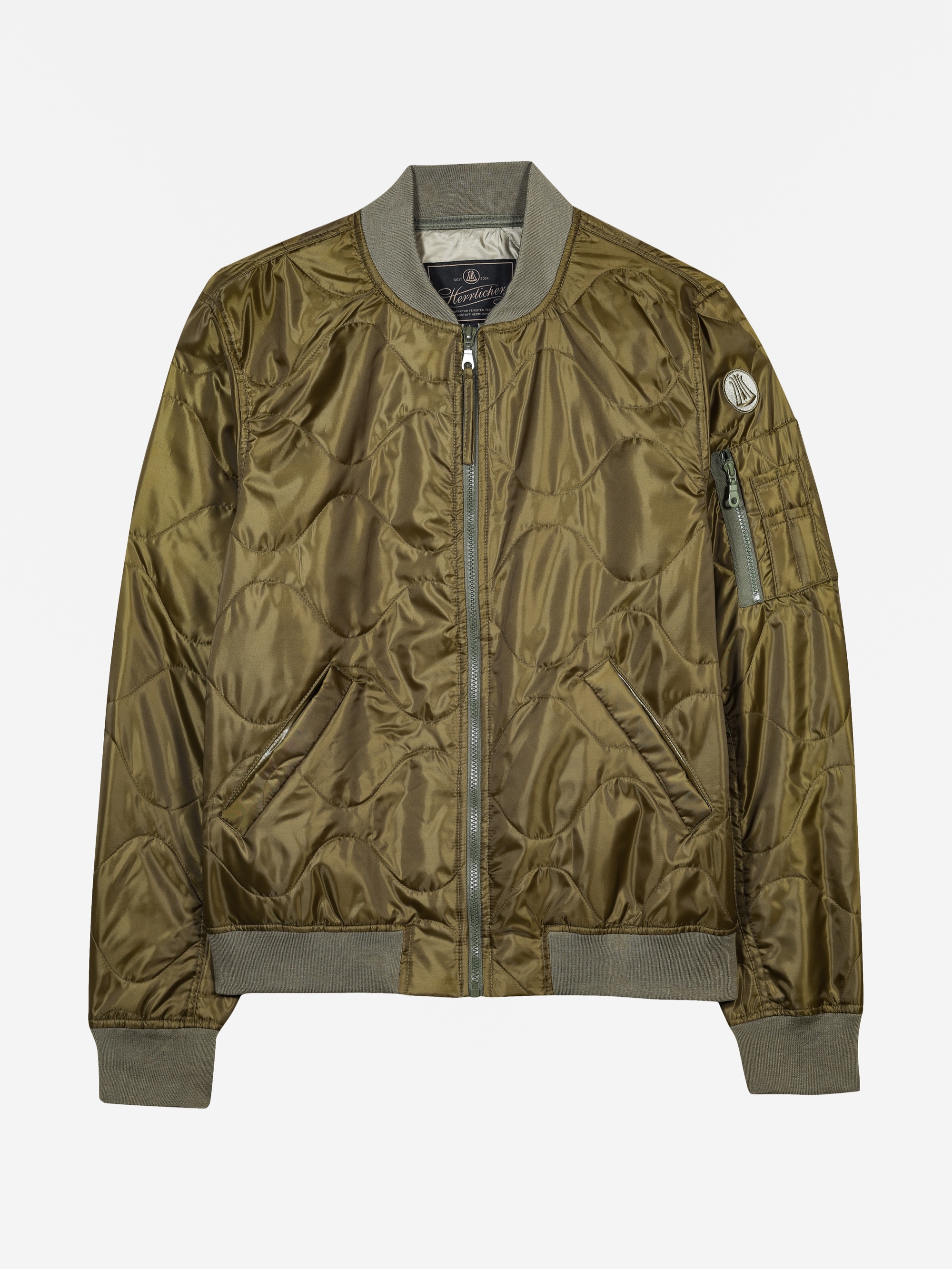 Olivgrüne, gesteppte Bomberjacke mit Frontreißverschluss, geripptem Kragen, Manschetten und Saum sowie einer Reißverschlusstasche am linken Ärmel.